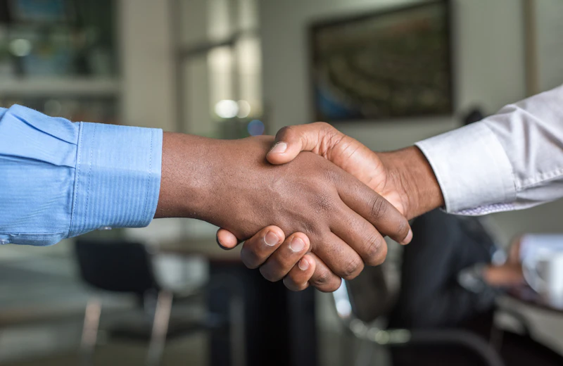 Two professionals shaking hands after a meeting